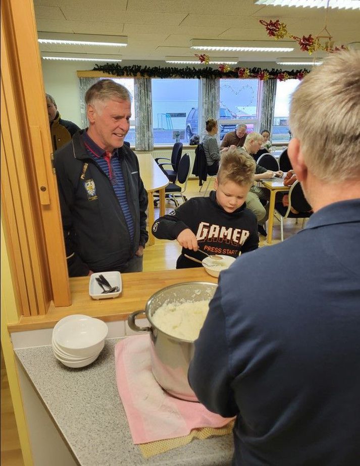 Hríseyingar komu saman í hádeginu og fengu sér mjólkurgraut og slátur í boði ferðafélags eyjunnar. Hér skammtar Þröstur Johan Jörundi graut og Ómar bíður þolinmóður á meðan.