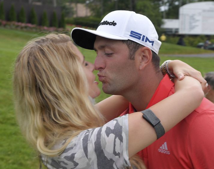 Jon Rahm og eiginkona hans Kelley Cahill fögnuðu sigrinum í gær með kossi.