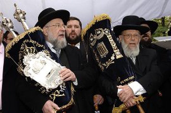 Rabbíarnir bera hérna ævafornar Torah ritningar í hið nýja bænahús.