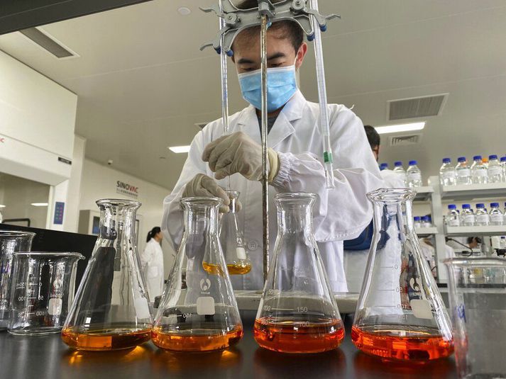 A worker works inside a lab at the SinoVac vaccine factory in Beijing on Thursday, Sept. 24, 2020. SinoVac, one of China's pharmaceutical companies behind a leading COVID-19 vaccine candidate says its vaccine will be ready by early 2021 for distribution worldwide, including the U.S. (AP Photo/Ng Han Guan)