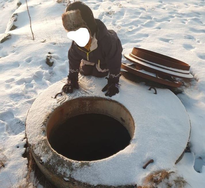 Sjö ára sonur Jóns og Rúnu við opið á holræsinu í dag, þar sem hann var á ferð í fylgd foreldra sinna.