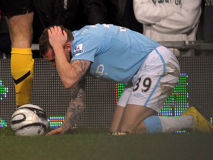 Craig Bellamy liggur hér í grasinu eftir að hafa fengið smápening í hausinn.