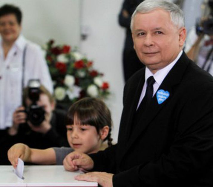 Jaroslaw Kaczynski greiðir atkvæði í Varsjá í morgun með barnabarni sínu.