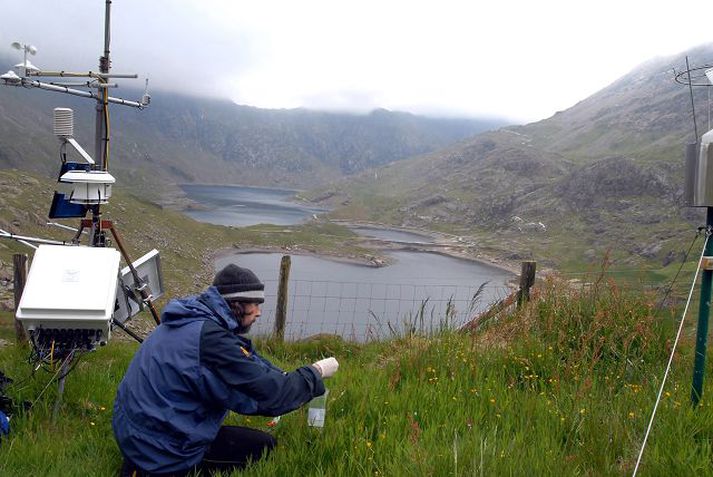 Alex McGregor, sjálfboðaliði hjá CCW, safnar sýnum á Snowdon. Llyn Llydow í baksýn.