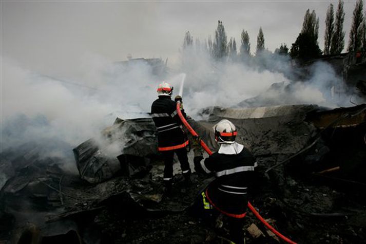 Slökkviliðsmenn við störf í Arras í Norður-Frakkalandi í morgun, en þar var m.a. kveikt í tveimur verslunum.