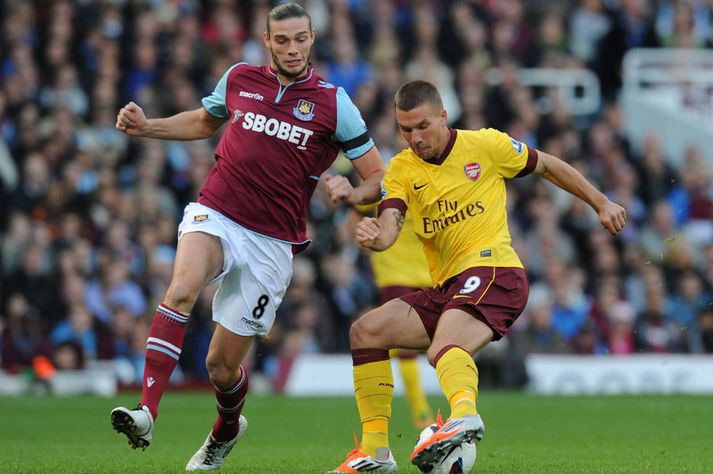 Andy Carroll og Lukas Podolski í viðureign liðanna á Upton Park í október. Arsenal vann 3-1 sigur.