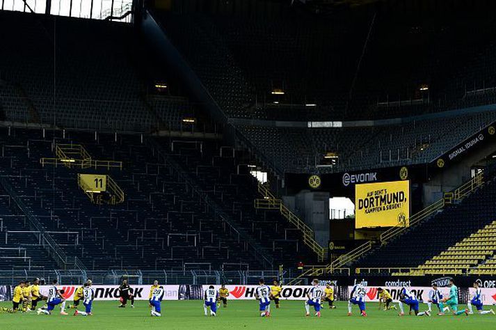 Mínútu þögn á hnjánum fyrir leik Dortmund og Herthu Berlínar í dag.