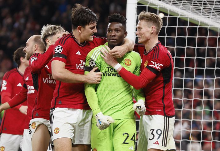 Harry Maguire og Scott McTominay fagna markverðinum Andre Onana eftir að hann varði víti og tryggði Manchester United sigur á FC Kaupmannahöfn.