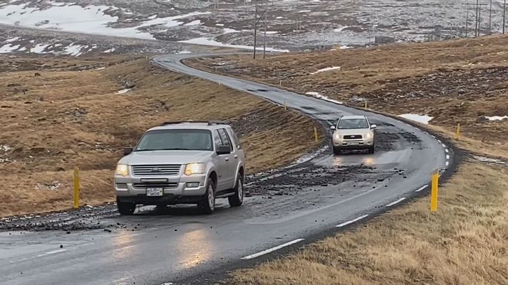 Frá Bíldudalsvegi í innanverðum Tálknafirði. Bílarnir þurfa að læðast yfir holurnar í slitlaginu.