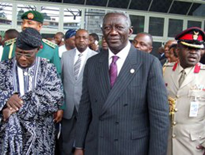John Kufuor forseti Gana, í miðju, á leið af áttunda leiðtogafundi Afríkusambandsins í dag. Olusegun Obasanjo forseti Nígeríu athugar hvað tímanum líður.