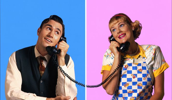 Couple with wistful expressions, using telephones (Composite)