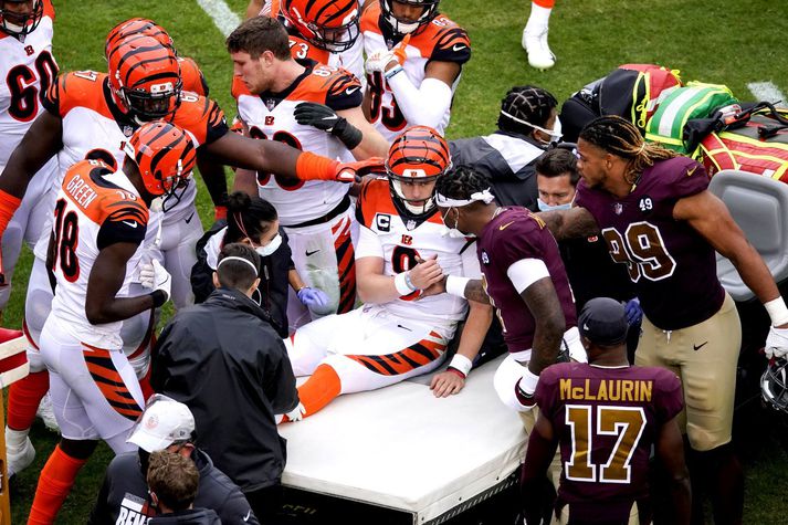 Leikmenn Cincinnati Bengals og Washington Football Team hópuðust í kringum Joe Burrow til að veita honum stuðning þegar hann var keyrður af velli eftir að hafa rústað hnénu á sér.