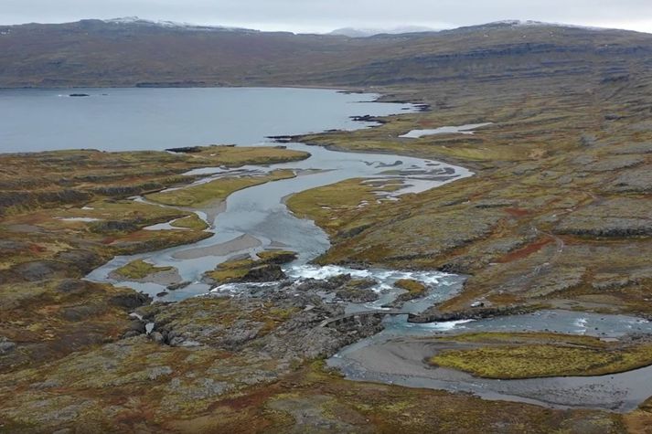 Séð yfir Hvalárfoss og ósa Hvalár þar sem vegurinn endar. Ófeigsfjörður í baksýn.