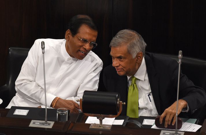 Sri Lanka's President Maithripala Sirisena (L) and Prime Minister Ranil Wickremesinghe (R) speak during a special session of the national parliament in Colombo on October 3, 2017. - Parliament marked its 70th anniversary with a commemorative session that had Speakers of South Asian countries attending as special invitees. (Photo by ISHARA S. KODIKARA / AFP)