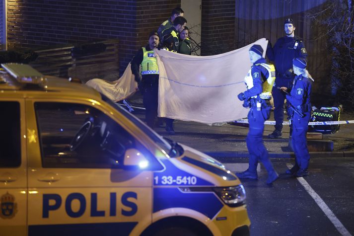 Police stand in the area where a man was found shot dead in Solna outside Stockholm Friday, Jan. 20, 2023. (Christine Olsson//TT News Agency via AP)