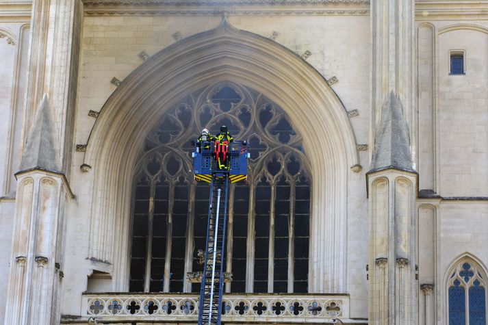 Fire fighters brigade work to extinguish the blaze at the Gothic St. Peter and St. Paul Cathedral, in Nantes, western France, Saturday, July 18, 2020. The fire broke, shattering stained glass windows and sending black smoke spewing from between its two towers of the 15th century, which also suffered a serious fire in 1972. The fire is bringing back memories of the devastating blaze in Notre Dame Cathedral in Paris last year that destroyed its roof and collapsed its spire and threatened to topple the medieval monument. (AP Photo/Laetitia Notarianni)