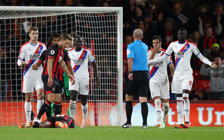 Sakho reynir að malda í móinn er Mike Dean bendir á punktinn.