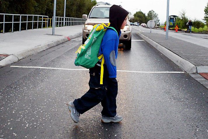 Hér fyrir ungur drengur yfir gangbraut við Hlíðarskóla. Pössum okkur á börnum í umferðinni. 