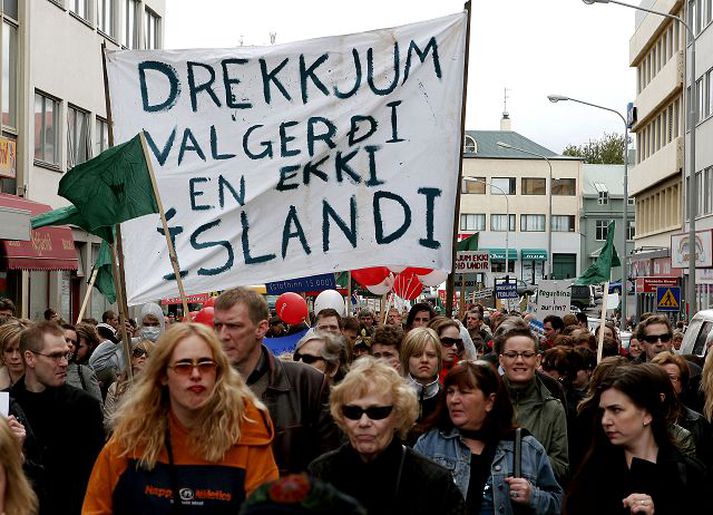 Protestors carry the banner down Laugavegur