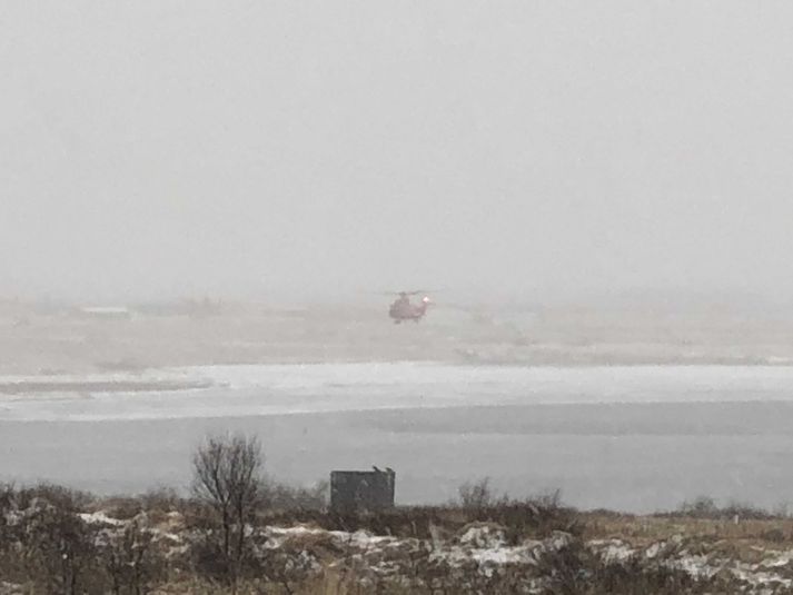 Þyrla Landhelgisgæslunnar yfir Ölfusá um tólfleytið í dag.