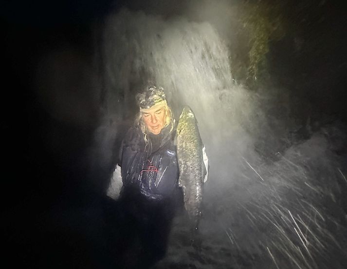 Jóhannes Sturlaugsson med sjókvíaeldislax vid ófiskgengan foss efst í Fífustaðadalsá í þessum mánuði.