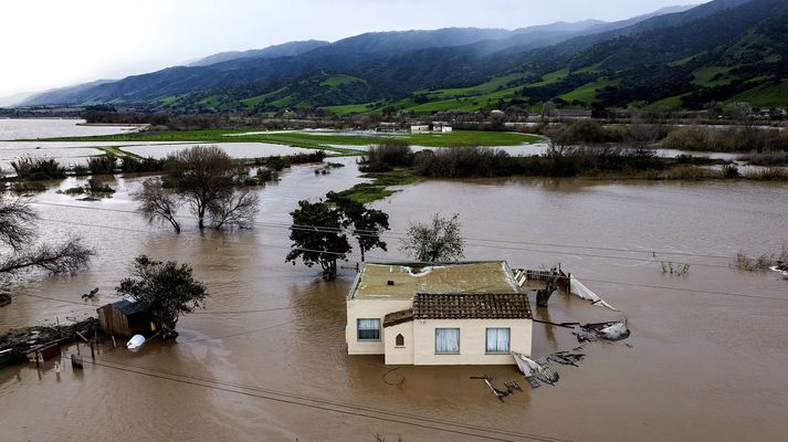 Salinas áin flæddi yfir bakka sína í Monterey-héraði og umlykur nú hús á svæðinu.