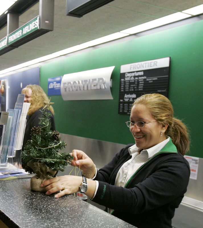 Ánægð með jólatréð Á hverju afgreiðsluborði er nú eitt lítið jólatré.