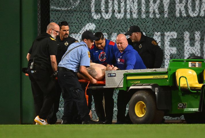 Bráðaliðar búa sig undir að flytja manninn sem féll niður um sex metra úr stúkunni á PNC Park, heimavelli Pittsburgh Pirates, af velli.