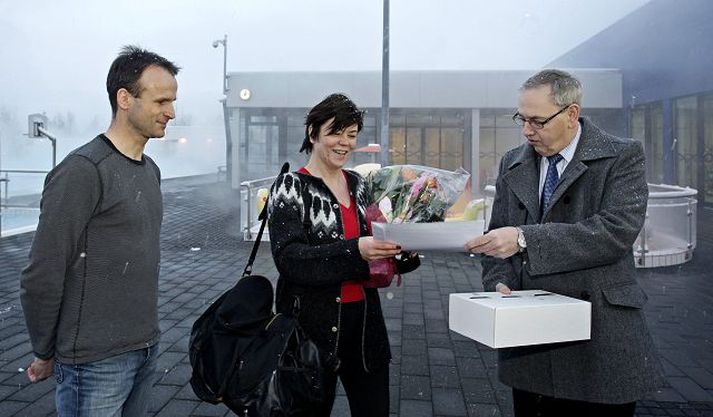glaðningur fyrir sundsprettinn María Níelsdóttir tók við blómvendi, árskorti í líkamsrækt og sund og fleiri gjöfum úr hendi Jakobs Þorsteinssonar og Gunnsteins Sigurðssonar áður en hún stakk sér til sunds í gær. fréttablaðið/valli