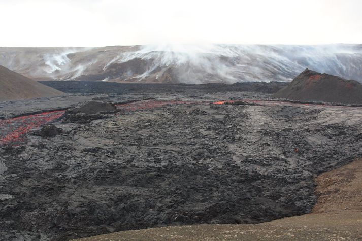 Reykur frá mosabrunasést í hlíðunum við hraunið í Geldingadölum.