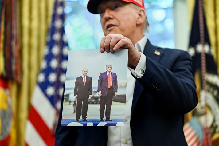 Trump með mynd af sér og Pútín þegar þeir hittust í Alaska í fyrra.