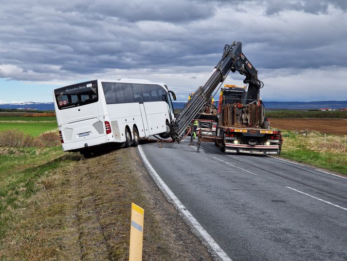 Hífa þurfti rútuna aftur upp á veginn.