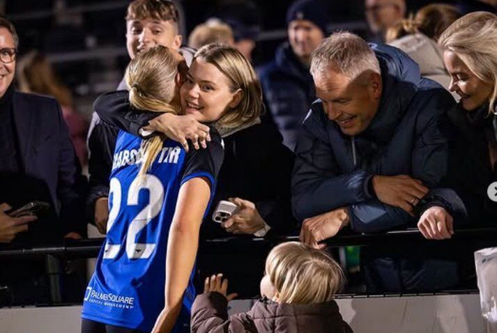 Emelía Óskarsdóttir faðmar systur sína Magneu við hlið foreldra þeirra, Laufeyjar Kristjánsdóttur og Óskars Hrafns Þorvaldssonar.