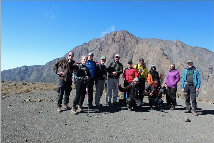 Hópurinn hress og kátur eftir að hafa toppað Mt. Meru (4565m), sem er í baksýn, fyrir viku.