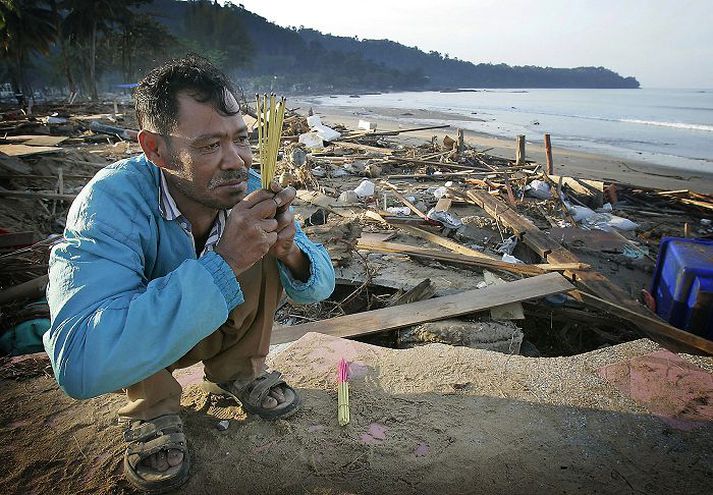 Á ströndinni við Khao Lak. Kusol Wetchakul fer með bænir sínar þann 29. desember árið 2004 í minningu systur sinnar, sem var ein þeirra sem létu lífið í hamförunum þremur dögum fyrr.