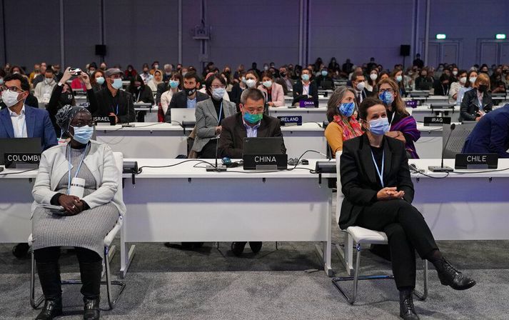 Delegates pack the hall at the COP26 U.N. Climate Summit in Glasgow, Scotland, Thursday, Nov. 11, 2021. (AP Photo/Alberto Pezzali)