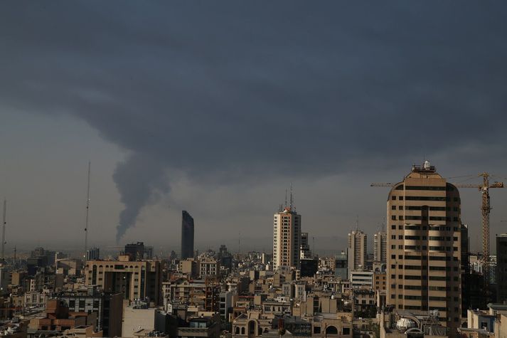 Mikill reykur eftir árás Ísraela á olíuvinnslu í útjaðri Tehran. 