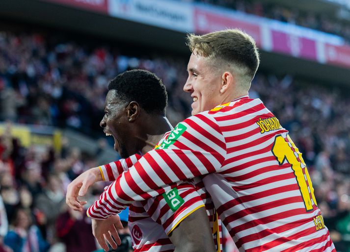 Ísak Bergmann Jóhannesson fagnar marki Ragnar Ache í dag en Kölnarliðið lék í þverröndóttum treyjum.