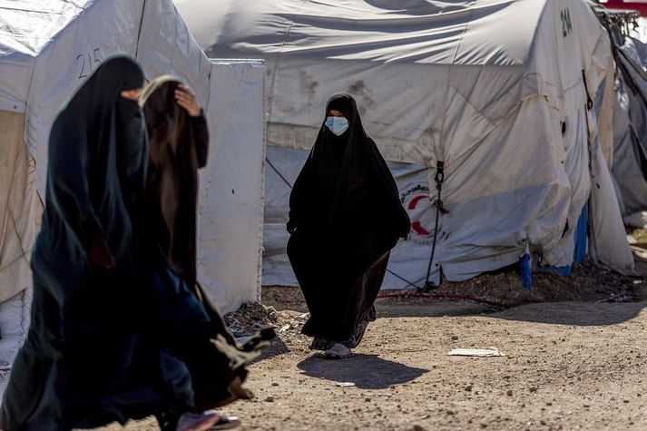 Konur á gangi í Roj-búðunum í norðausturhluta Sýrlands. Sýrlenskir Kúrdar hafa haldið tugum þúsunda erlendra ISIS-liða og fjölskyldum þeirra í nokkur ár og segja að ábyrgðin eigi ekki eingöngu að vera á þeirra höndum.