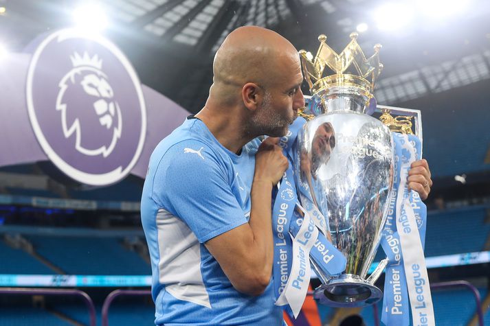 Manchester City v Aston Villa - Premier League MANCHESTER, ENGLAND - MAY 22: Pep Guardiola the head coach / manager of Manchester City kisses the Premier League trophy during the Premier League match between Manchester City and Aston Villa at Etihad Stadium on May 22, 2022 in Manchester, United Kingdom. (Photo by Robbie Jay Barratt - AMA/Getty Images)