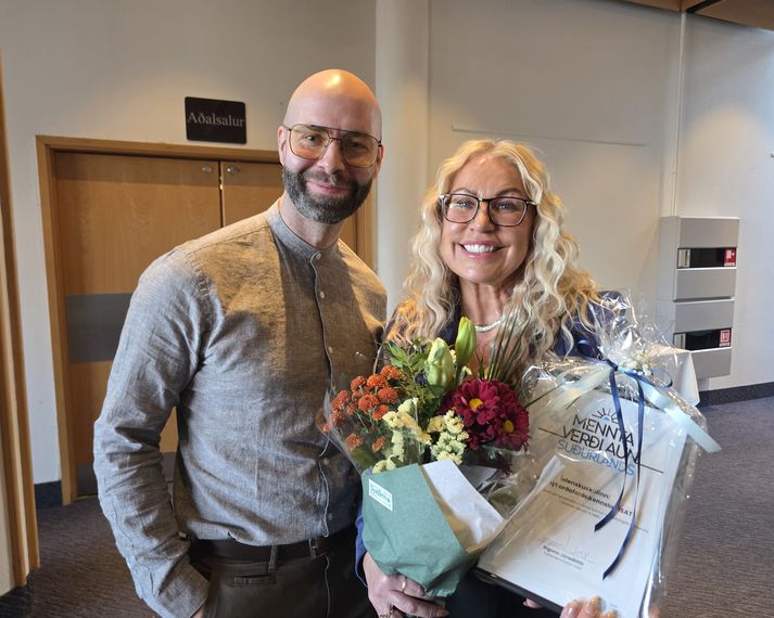 Menntaverðlaun Suðurlands fóru til Grunnskólans á Hellu en hér eru þau Ragnheiður Gísladóttir, kennari og Kristinn Ingi Austmar Guðnason, aðstoðarskólastjóri  með verðlaunaskjalið og blóm.