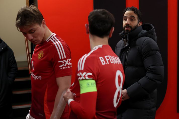 Ruben Amorim, þjálfari Manchester United, ræðir við fyrirliðann Bruno Fernandes í leikmannagöngunum á Old Trafford.